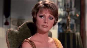 Movie still from “Lisa and the Devil” (1973), directed by Mario Bava – A person with short brown hair; Close Up shot, Over the shoulder angle