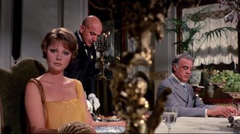Movie still from “Lisa and the Devil” (1973), directed by Mario Bava – A man and a woman sitting at a dinner table; Medium shot, Over the shoulder angle