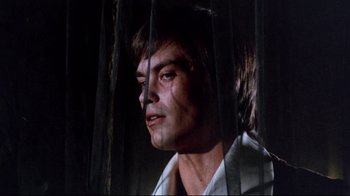 Movie still from “Lisa and the Devil” (1973), directed by Mario Bava – A person looking through a fence; Close Up shot, Low angle