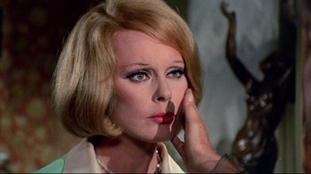 Movie still from “Lisa and the Devil” (1973), directed by Mario Bava – A person with a hand on her face; Close Up shot, Over the shoulder angle