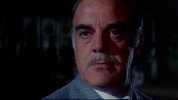 Movie still from “Lisa and the Devil” (1973), directed by Mario Bava – A man with a mustache wearing a suit; Close Up shot, Low angle