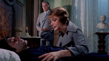 Movie still from “Lisa and the Devil” (1973), directed by Mario Bava – An older man and a woman in a room; Medium shot, Over the shoulder angle