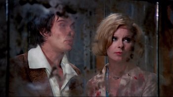 Movie still from “Lisa and the Devil” (1973), directed by Mario Bava – A man and a woman standing next to each other; Medium shot, Low angle