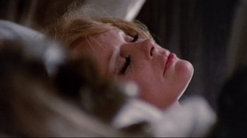 Movie still from “Lisa and the Devil” (1973), directed by Mario Bava – A young girl is laying down with her eyes closed; Close Up shot, High angle