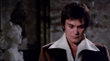 Movie still from “Lisa and the Devil” (1973), directed by Mario Bava – A man in a brown jacket is looking down; Close Up shot, High angle