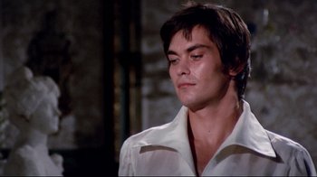 Movie still from “Lisa and the Devil” (1973), directed by Mario Bava – A man in a white shirt is looking down; Close Up shot, Low angle