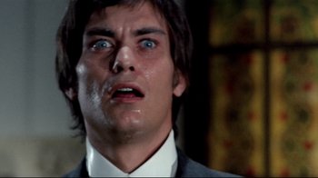 Movie still from “Lisa and the Devil” (1973), directed by Mario Bava – A person wearing a suit and tie; Close Up shot, Low angle