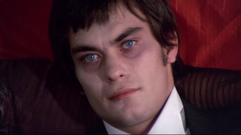 Movie still from “Lisa and the Devil” (1973), directed by Mario Bava – A person wearing a suit and tie; Close Up shot, High angle