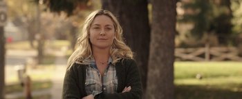 Movie still from “Wish Upon” (2017), directed by John R. Leonetti – A woman standing next to a tree with her arms crossed; Close Up shot, Over the shoulder angle