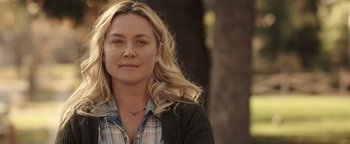 Movie still from “Wish Upon” (2017), directed by John R. Leonetti – A woman with long blonde hair wearing a checkered shirt; Close Up shot, Over the shoulder angle