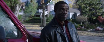 Movie still from “Wish Upon” (2017), directed by John R. Leonetti – A man standing next to a car on the side of the road; Close Up shot, Over the shoulder angle