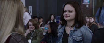 Movie still from “Wish Upon” (2017), directed by John R. Leonetti – A group of young people sitting in a room together; Medium shot, Over the shoulder angle