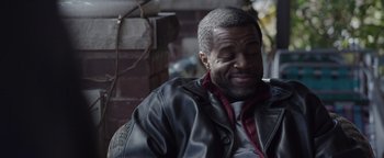 Movie still from “Wish Upon” (2017), directed by John R. Leonetti – A man sitting down with his eyes closed; Close Up shot, Over the shoulder angle
