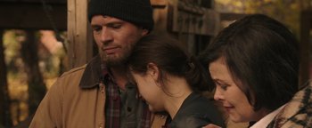 Movie still from “Wish Upon” (2017), directed by John R. Leonetti – A man and a woman are standing next to each other; Close Up shot, Over the shoulder angle