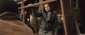 Movie still from “Wish Upon” (2017), directed by John R. Leonetti – A young woman holding onto a wooden beam; Medium shot, Over the shoulder angle