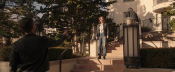 Movie still from “Wish Upon” (2017), directed by John R. Leonetti – A woman standing on the steps of a house; Wide shot, Over the shoulder angle