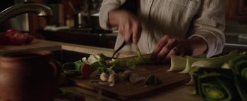 Movie still from “Wish Upon” (2017), directed by John R. Leonetti – A person cutting vegetables on top of a cutting board; Extreme Close Up shot, High angle