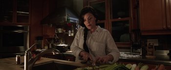 Movie still from “Wish Upon” (2017), directed by John R. Leonetti – A woman cutting celery in a kitchen with dark lighting; Close Up shot, Low angle