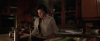 Movie still from “Wish Upon” (2017), directed by John R. Leonetti – A woman in a kitchen preparing food on a cutting board; Close Up shot, Over the shoulder angle