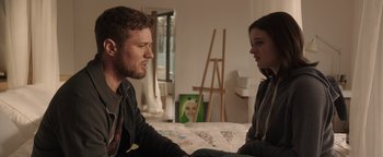 Movie still from “Wish Upon” (2017), directed by John R. Leonetti – A man and a woman sitting on a bed talking to each other; Medium shot, Over the shoulder angle