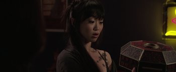 Movie still from “Wish Upon” (2017), directed by John R. Leonetti – A woman with a tattoo on her arm is looking at the camera; Close Up shot, High angle
