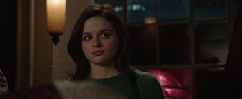 Movie still from “Wish Upon” (2017), directed by John R. Leonetti – A woman with long brown hair wearing a green sweater; Close Up shot, Over the shoulder angle