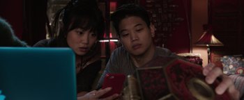 Movie still from “Wish Upon” (2017), directed by John R. Leonetti – A man and a woman looking at a cell phone; Close Up shot, High angle