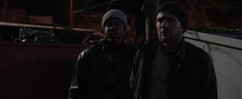 Movie still from “Wish Upon” (2017), directed by John R. Leonetti – A couple of men standing next to each other in the dark; Medium shot, Low angle