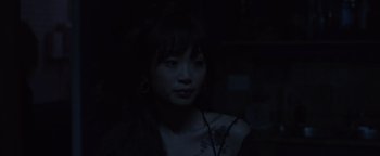 Movie still from “Wish Upon” (2017), directed by John R. Leonetti – A young woman is looking into the dark; Close Up shot, High angle