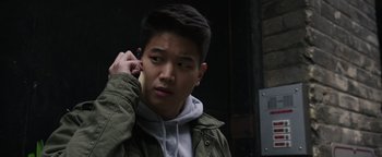 Movie still from “Wish Upon” (2017), directed by John R. Leonetti – A young man is talking on a cell phone; Close Up shot, High angle