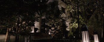 Movie still from “Wish Upon” (2017), directed by John R. Leonetti – A building that is lit up at night time; Extreme Wide shot, Low angle