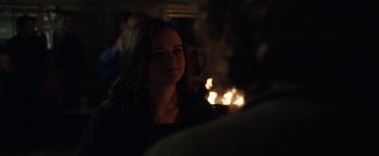 Movie still from “Wish Upon” (2017), directed by John R. Leonetti – A woman in a black jacket is looking into the distance; Close Up shot, Over the shoulder angle