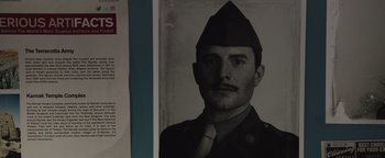 Movie still from “Wish Upon” (2017), directed by John R. Leonetti – An old photo of a man wearing a hat and a tie; Extreme Close Up shot, Overhead angle