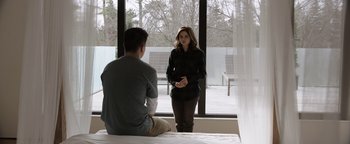 Movie still from “Wish Upon” (2017), directed by John R. Leonetti – A man and a woman sitting in front of a window; Medium shot, Over the shoulder angle