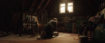 Movie still from “Wish Upon” (2017), directed by John R. Leonetti – A woman kneeling on the floor in a room; Wide shot, Overhead angle