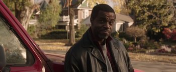 Movie still from “Wish Upon” (2017), directed by John R. Leonetti – A man wearing a leather jacket standing in front of a red car; Close Up shot, Over the shoulder angle
