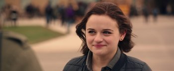 Movie still from “Wish Upon” (2017), directed by John R. Leonetti – A person smiling for the camera; Close Up shot, Over the shoulder angle