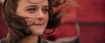 Movie still from “Wish Upon” (2017), directed by John R. Leonetti – A young woman's face and hair; Close Up shot, Over the shoulder angle