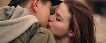 Movie still from “Wish Upon” (2017), directed by John R. Leonetti – A man and a woman kissing in a car; Extreme Close Up shot, Low angle