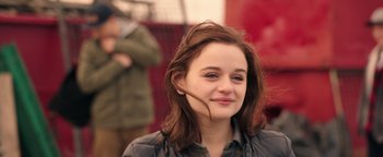Movie still from “Wish Upon” (2017), directed by John R. Leonetti – A woman with a long brown hair is smiling for the camera; Close Up shot, Over the shoulder angle