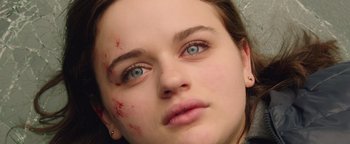 Movie still from “Wish Upon” (2017), directed by John R. Leonetti – A young woman's blue eyes with red marks on her face; Close Up shot, Overhead angle