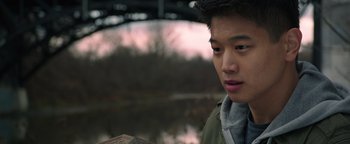 Movie still from “Wish Upon” (2017), directed by John R. Leonetti – A young man is looking down at a piece of paper; Close Up shot, Over the shoulder angle