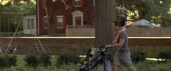 Movie still from “Little Children” (2006), directed by Todd Field – A man pushing a baby in a stroller; Medium shot, Low angle