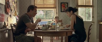 Movie still from “Little Children” (2006), directed by Todd Field – A man and two boys sitting at a table eating; Medium shot, Low angle