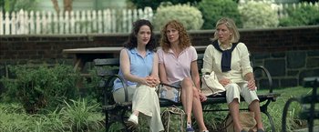 Movie still from “Little Children” (2006), directed by Todd Field – A group of women sitting on top of a wooden bench; Medium shot, High angle