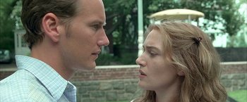 Movie still from “Little Children” (2006), directed by Todd Field – A man and a woman face to face in front of a brick wall; Close Up shot, Low angle