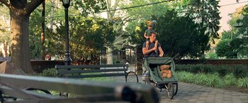 Movie still from “Little Children” (2006), directed by Todd Field – A man and a child are riding a cart; Wide shot, Over the shoulder angle
