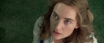 Movie still from “Little Children” (2006), directed by Todd Field – A woman's face with green eyes; Close Up shot, Overhead angle