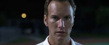 Movie still from “Little Children” (2006), directed by Todd Field – A man's face in a white shirt; Close Up shot, Low angle