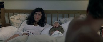 Movie still from “Little Children” (2006), directed by Todd Field – A woman laying in a bed with a boy; Close Up shot, Over the shoulder angle